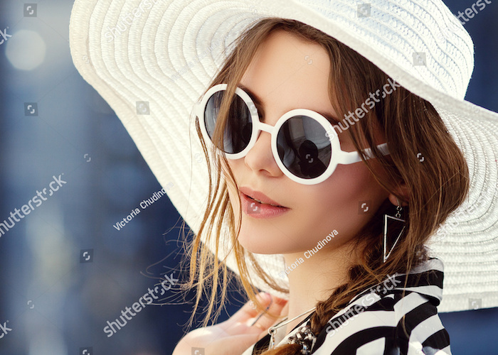 Woman wearing sunglasses and a hat